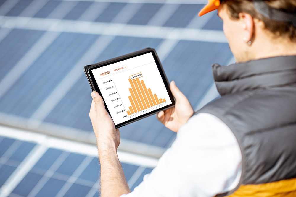 Examining production of solar power plant with digital tablet